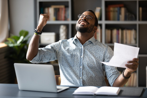 Happy-man_fist-pump_paper_computer