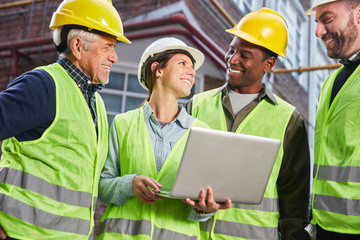 Happy-industry-workers-laptop_AdobeStock_247940763-sma